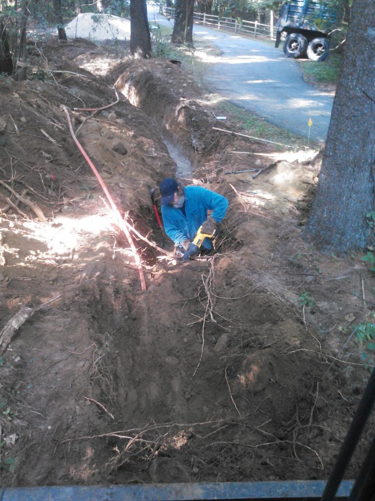 clearing tree root for trench trench for electric line